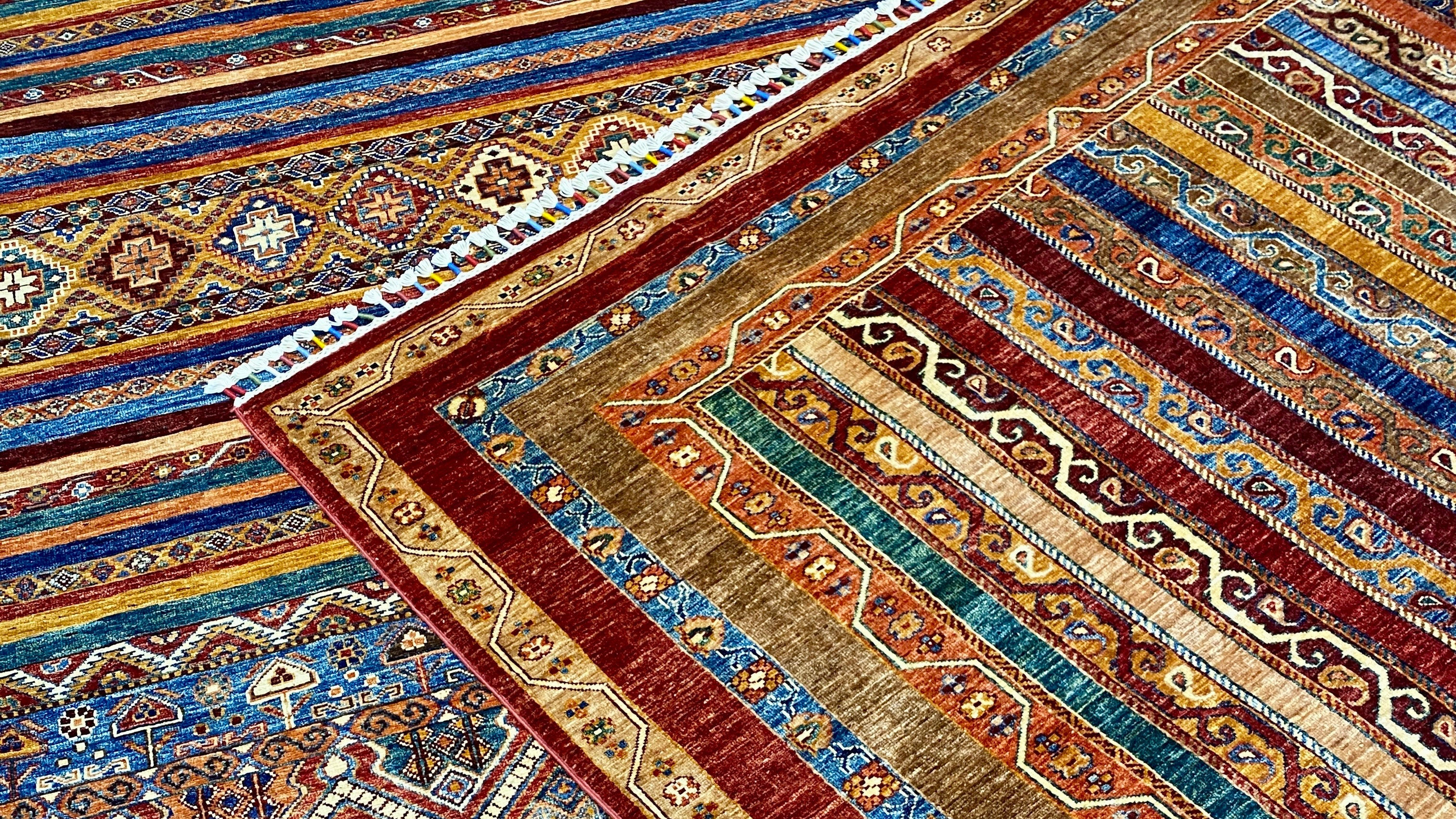 Close-up of intricately patterned rugs with a focus on colors and designs.
